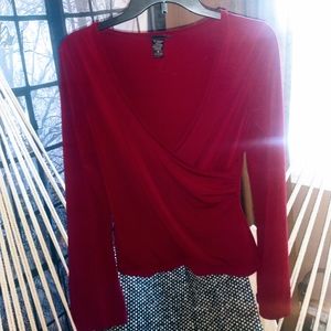 Red wrap around blouse with long sleeves.